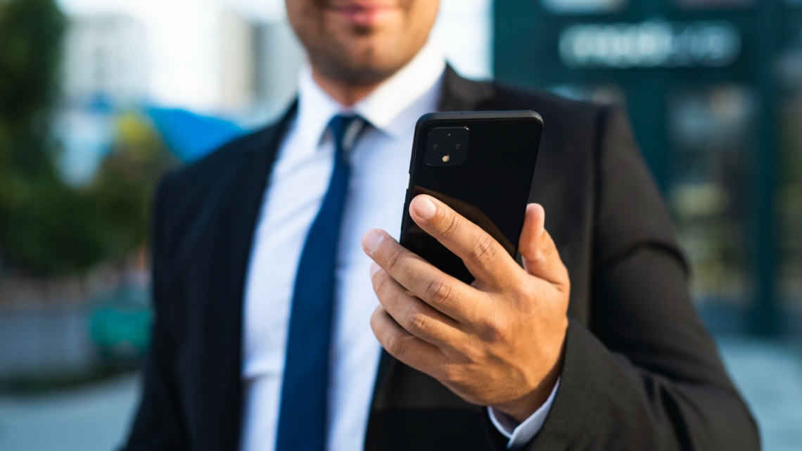 Corporate man holding phone