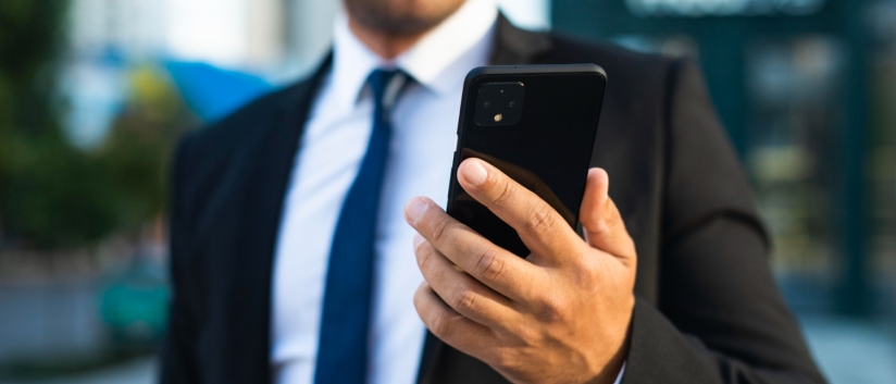 Corporate man holding phone