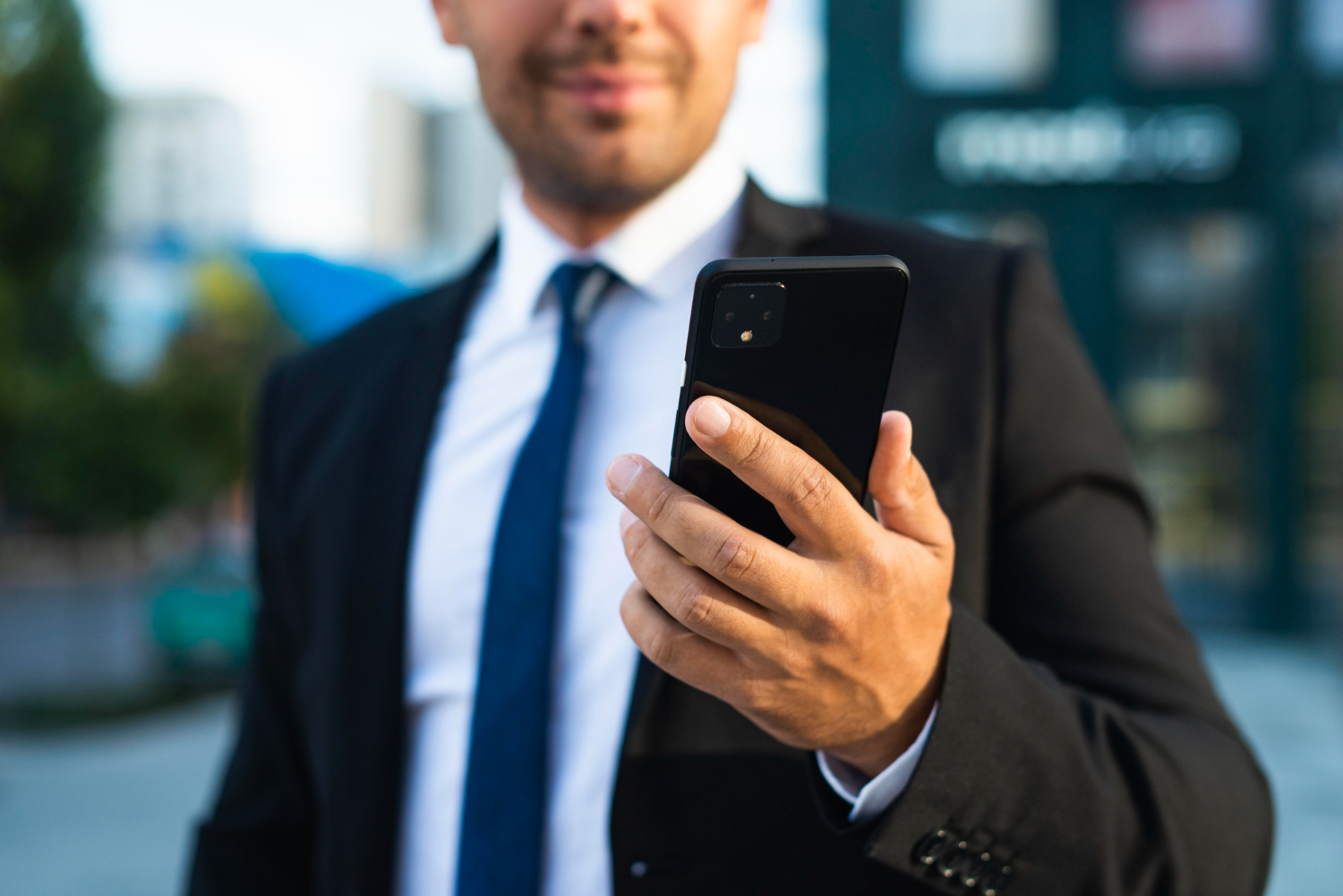 Corporate man holding phone